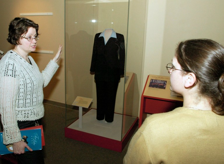 Margaret Koch, exhibition designer for the "First Ladies: Political Role and Public Image" exhibition, tells about the pantsuit worn by former first lady Hillary Rodham Clinton. (AP Photo/Tom Gannam)