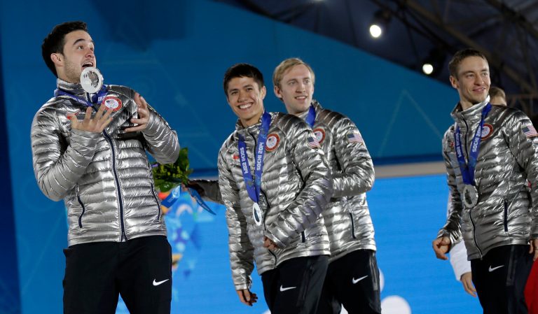 The team from the United States, who won the silver medal in the men's short track speedskating 5,000-meter relay, smile while exiting the stage following their medals ceremony at the 2014 Winter Olympics, Saturday, Feb. 22, 2014, in Sochi, Russia. (AP Photo/David Goldman)