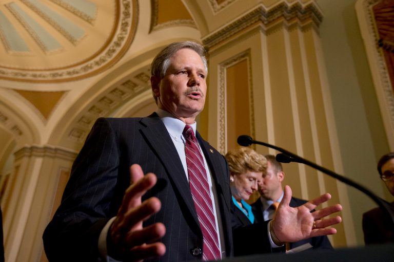 In this photo taken June 10, 2013, Sen. John Hoeven, N.D., speaks to reporters as the Senate votes on a farm bill, on Capitol Hill in Washington. Hoeven and Sen. Bob Corker, R-Tenn., are pushing an amendment on the current immigration bill that would strengthen border security. (AP Photo/J. Scott Applewhite)