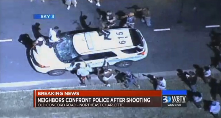 A police vehicle is damaged after protests broke out Tuesday in Charlotte, N.C., following a fatal shooting of a black man by police. (WBTV via AP)