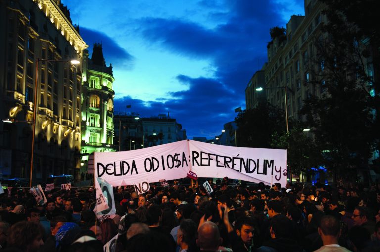 Protestors gather near Parliament demonstrating against austerity measures announced by the Spanish government in Madrid, Spain, Saturday, Sept. 29, 2012. Tens of thousands of Spaniards and Portuguese rallied in the streets to protest enduring deep economic pain from austerity cuts. In Madrid, demonstrators approached parliament for the third time this week to vent their anger against tax hikes, government spending cuts and the highest unemployment rate among the 17 nations that use the euro. Banner reads 'Hate debt, referendum'.(AP Photo/Daniel Ochoa De Olza)