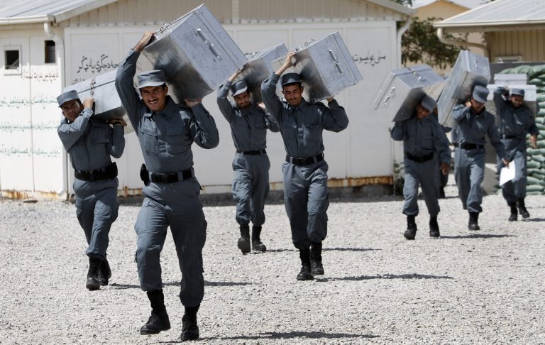 Afghan National Police officers carry boxes of equipment during their graduation ceremony at a National Police training center in Jalalabad, east of Kabul, Afghanistan, Thursday, August 30, 2012. (AP Photo/Rahmat Gul)