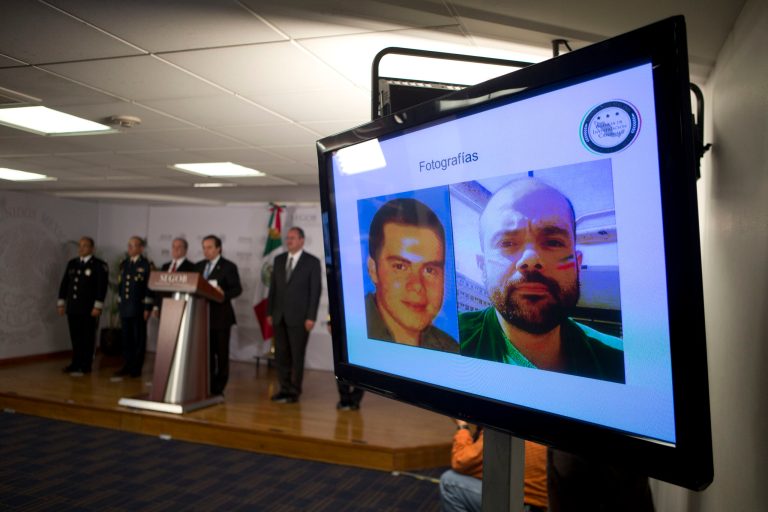 Federal officials display photographs of Fernando Sanchez Arellano, head of the Arellano Felix cartel, at a press conference to announce his capture, in Mexico City, Tuesday, June 24, 2014. The head of the once-mighty Tijuana-based Arellano Felix cartel was arrested in Mexico while watching the Mexican soccer team play in the World Cup, a top federal official said Tuesday. (AP Photo/Rebecca Blackwell)