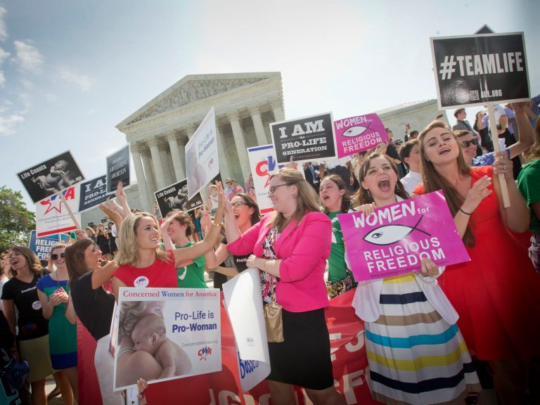 Demonstrator react to hearing the Supreme Court's decision on the Hobby Lobby case outside the Supreme Court in Washington, June 30. The Supreme Court says corporations can hold religious objections that allow them to opt out of the new health law requirement that they cover contraceptives for women. (AP Photo/Pablo Martinez Monsivais)
