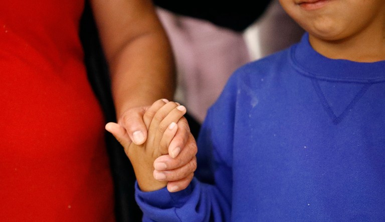 Darwin Micheal Mejia, right, holds hands with his mother, Beata Mariana de Jesus Mejia-Mejia, during a news conference following their reunion at Baltimore-Washington International Thurgood Marshall Airport, Friday, June 22, 2018, in Linthicum, Md. The Justice Department agreed to release Mejia-Mejia's son after she sued the U.S. government in order to be reunited following their separation at the U.S. border. She has filed for political asylum in the U.S. following a trek from Guatemala.