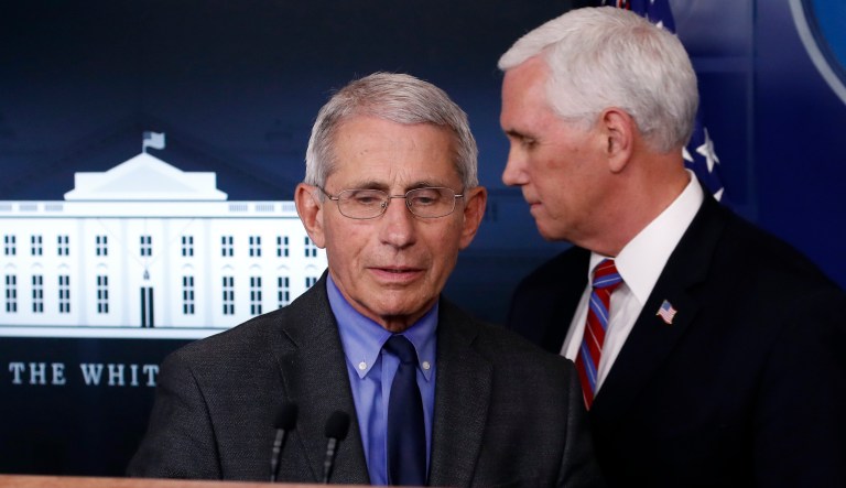 Dr. Anthony Fauci, director of the National Institute of Allergy and Infectious Diseases, walks to the podium past Vice President Mike Pence to speak about the coronavirus in the James Brady Press Briefing Room at the White House, Monday, April 13, 2020, in Washington.