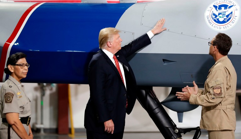 President Trump was spotted petting a large U.S. Customs and Border Protection drone during his tour of the Yuma Border Patrol Station in southern Arizona on Tuesday. (AP Photo/Alex Brandon)