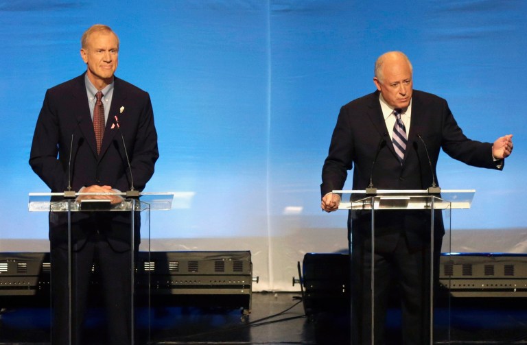 FILE - In this Oct. 14, 2014 file photo, Illinois gubernatorial candidates Republican Bruce Rauner, left, and incumbent Democrat Gov. Pat Quinn participate in a debate in Chicago. There is a $1 billion disagreement between the two on whether spending on public education in Illinois has increased or decreased under Quinn. Rauner alleges that Quinn decreased school aid nearly $600 million since taking office in 2009. Quinn says he's increased it by more than $400 million. (AP Photo/Charles Rex Arbogast, File)