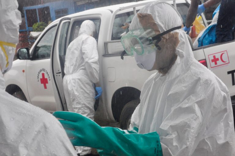 Health workers dressed in protective gear prepare to load the body of a woman suspected to have died from Ebola virus, in New Kru Town at the outskirt of  Monrovia, Liberia, Wednesday, Oct. 8, 2014. Liberia has been among the hardest hit nations at the centre of the long outbreak, which has killed more than 3,000 people, as of Friday, there had been 3,834 confirmed Ebola cases and 2,069 deaths in Liberia, according to the World Health Organization. Forty-four percent of the Ebola cases were reported in the past three weeks, a signal that the infectious disease is spreading.(AP Photo/Abbas Dulleh)
