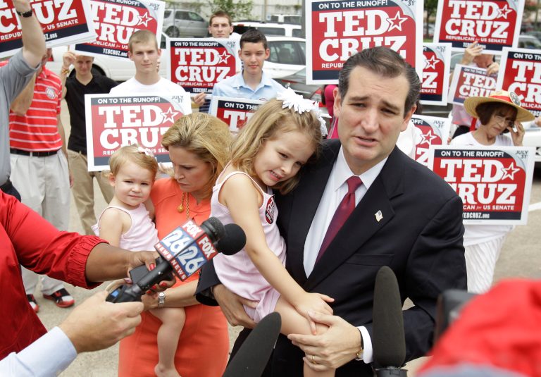 Ted Cruz, Republican candidate for U.S. Senate,  holds his daughter, Caroline, 4, as his wife, Heidi Cruz holds their daughter, Catherine, 1, while he speaks to the media before voting during the first day of early voting at the Metropolitan Multi-Service Center, in Houston, Monday, July 23, 2012. (AP Photo/Houston Chronicle, Melissa Phillip)