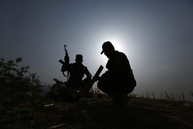 Iraqi Kurdish soldiers pause from combat to make tea near to the front line in Mahmoudiyah, Iraq, a day after they take control of the village from the Islamic State group, as they patrol on Wednesday, Oct. 1, 2014. Iraqi Kurdish fighters on the front lines of battle say they have yet to receive the heavy weapons and training pledged by the United States and nearly a dozen other countries to help them push back the Sunni militants. Without more sophisticated weaponry, the Kurdish fighters, known as peshmerga, have had to rely on aging arms like the Soviet-era cannons, a centerpiece of the offensive Tuesday to retake Mahmoudiyah. (AP Photo/Hadi Mizban)