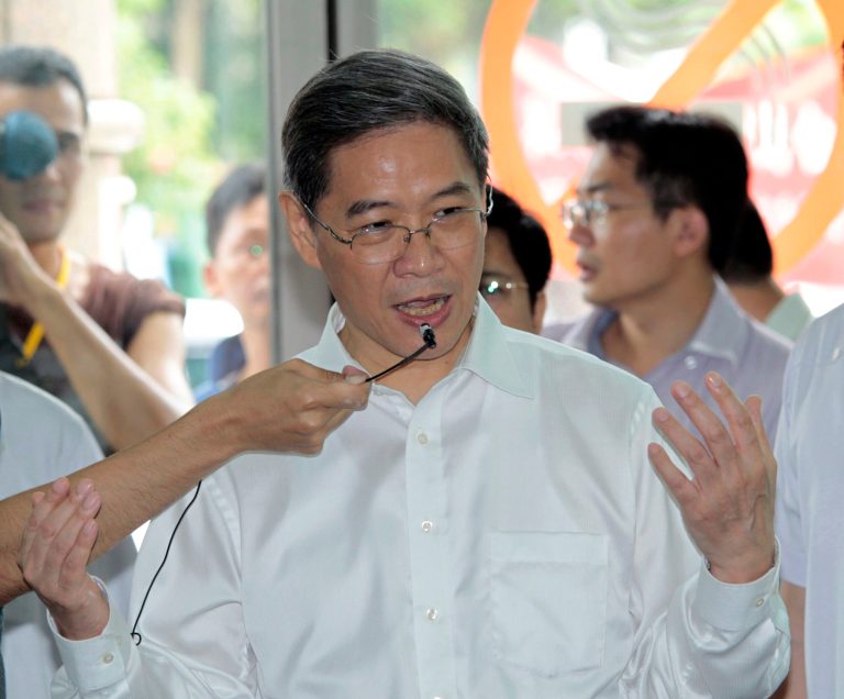 FILE - In this June 26, 2014 file photo, China's Taiwan Affairs Office Minister Zhang Zhijun speaks to media after his visit with officials at the city hall in New Taipei City, Taiwan. The Chinese envoy on a historic visit to Taiwan on Saturday, June 28 canceled two events after protesters threw paint on his motorcade. Zhang skipped visits to a fishing harbor and another village in southern Taiwan, but kept the rest of his schedule despite the continuing protests. (AP Photo/Wally Santana, File)