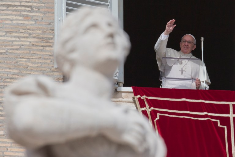 Pope Francis delivers his blessing to the crowd gathered in St. Peter's Square at the Vatican to attend the Angelus noon prayer he celebrated from the window of his studio, Sunday, Feb. 16, 2014. (AP Photo/Andrew Medichini)