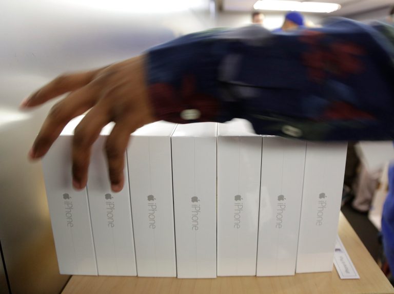 FILE - In this Sept. 19, 2014 file photo, an Apple store employee arranges a stack of pre-ordered iPhone 6 Plus models, in New York. Apple on Monday, Sept. 22, 2014 said it sold more than 10 million iPhone 6 and 6 Plus models, a record for a new model, in the three days after the phones went on sale. (AP Photo/Julie Jacobson, File)