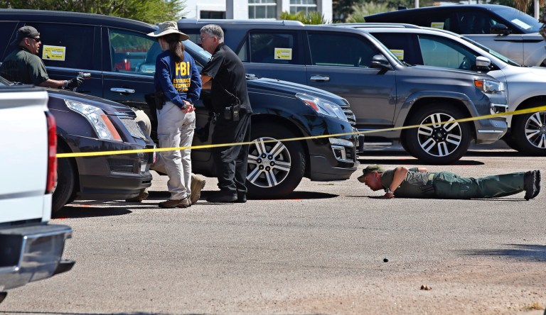 Officials continue to work the scene where 15-year-old Leilah Hernandez was shot and killed at a car dealership during Saturday's shooting incident Monday, Sept. 2, 2019, in Odessa, Texas. 