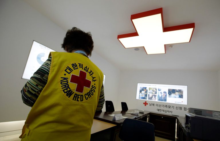 A South Korean volunteer works at a reception area where reunion applications for families separated by the Korean War are submitted, at the headquarters of Korean Red Cross in Seoul, South Korea, Monday, Jan. 27, 2014. South Korea on Monday proposed that the rival Koreas restart arranging reunions next month for families separated by the 1950-53 Korean War. (AP Photo/Lee Jin-man)