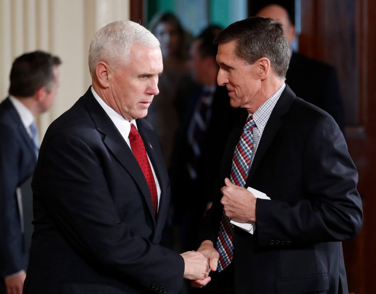 Vice President Mike Pence and National Security Adviser Michael Flynn, right, shake hands before the start of the President Donald Trump and Japanese Prime Minister Shinzo Abe joint new conference in the East Room of the White House, in Washington, Friday, Feb. 10, 2017. (AP Photo/Carolyn Kaster)