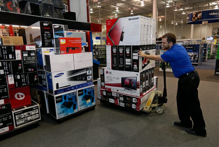FILE -In this Tuesday, Nov. 26, 2013, file photo, Chris Busch, multichannel sales support manager at an Oklahoma City Best Buy store, moves inventory at the store in Oklahoma City, Tuesday, Nov. 26, 2013. The government reports how much U.S. businesses adjusted their stockpiles in November on Tuesday, Jan. 14, 2014. (AP Photo/Sue Ogrocki, File)