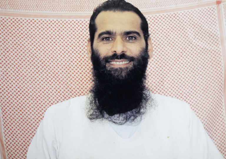   In this undated photo taken by the International Red Cross and provided by the family of Muhammed Rahim al-Afghani, Muhammed Rahim al-Afghani poses for a photo at Guantanamo Bay prison at the U.S. Naval Base in Cuba. Rahim who is being held with the most significant terrorism suspects in U.S. custody has apparently gained extensive knowledge of western pop culture in Guantanamo's Camp 7: the top secret prison-within-a-prison in Guantanamo Bay. Nearly five years ago, Rahim became the last prisoner sent to Guantanamo. He was accused of helping Osama bin Laden elude capture. (AP Photo/International Red Cross via Rahim family)  