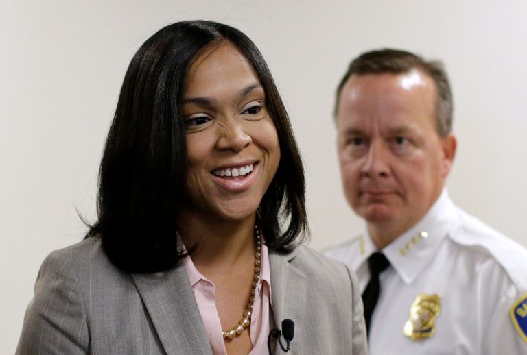 Baltimore State's Attorney Marilyn Mosby, left, leads Interim Baltimore Police Commissioner Kevin Davis into a classroom to meet with students participating in a junior state's attorney program, Thursday, July 9, 2015, in Baltimore. (AP Photo/Patrick Semansky)