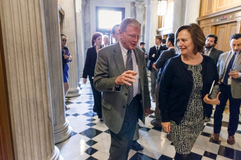 Sen. James Inhofe, R-Okla., talks with Sen. Deb Fischer, R-Neb. as they head to the Senate floor on Capitol Hill in Washington, Friday, Feb. 27, 2015. (AP Photo/J. Scott Applewhite)