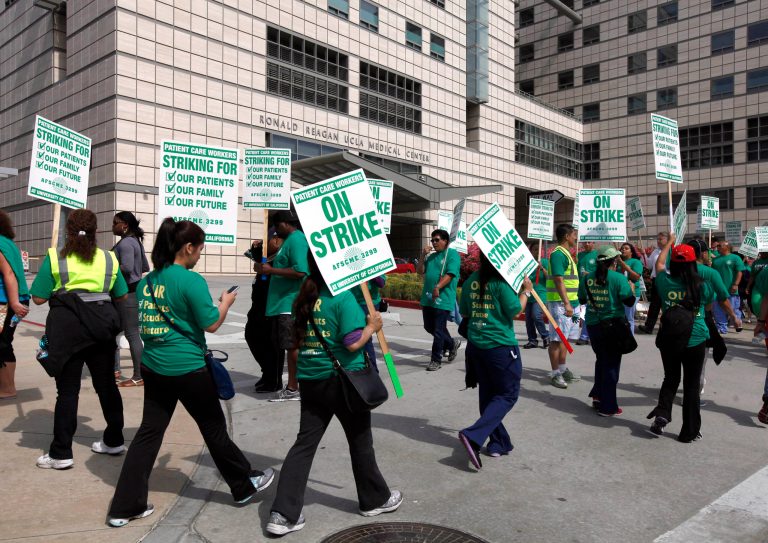 UCLA Medical Center health care workers walk the picket line during a two-day strike, Tuesday May 21, 2013 in Los Angeles. (AP Photo/Nick Ut)