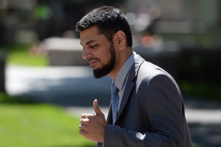 Khurram Syed Sher gives a thumbs up outside court in Ottawa, Ontario, on Tuesday, Aug. 19, 2014, after he was found not guilty of conspiring to facilitate terrorism. (AP Photo/The Canadian Press, Sean Kilpatrick)