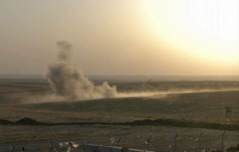 This image made from AP video shows smoke rising from airstrikes targeting Islamic State militants near the Khazer checkpoint outside of the city of Irbil in northern Iraq, Friday, Aug. 8, 2014. The Iraqi Air Force has been carrying out strikes against the militants, and for the first time on Friday, U.S. war planes have directly targeted the extremist Islamic State group, which controls large areas of Syria and Iraq.(AP Photo via AP video)