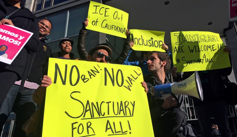 Protesters this year gathered outside the courthouse where a federal judge has heard arguments in the first lawsuit challenging President Trump's executive order to withhold funding from communities that limit cooperation with immigration authorities in San Francisco, a so-called 