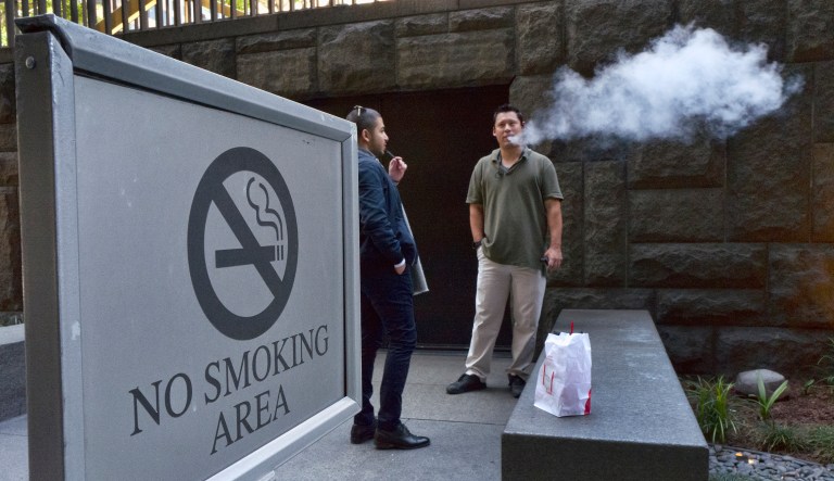 Office workers take a vaping break in downtown Los Angeles on Thursday, May 3, 2018. Federal health officials on Tuesday announced a nationwide crackdown on underage use of a popular e-cigarette brand following months of complaints from parents, politicians and school administrators.
