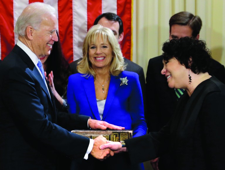 Vice President Joe Biden, with his wife Jill Biden, center, holding the Biden Family Bible, shakes hands with Supreme Court Justice Sonia Sotomayor after taking the oath of office during an official ceremony at the Naval Observatory, Sunday, Jan. 20, 2013, in Washington. (AP Photo/Carolyn Kaster)