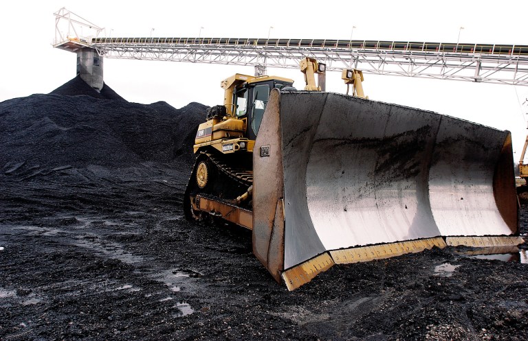 FILE - In this March 9, 2006 file photo, a large dozer sit ready for work at Peabody Energy's Gateway Coal Mine near Coulterville, Ill. A 10 percent reduction in carbon dioxide emissions will mean a decline of 180 million tons, or 18 percent, in U.S. coal production, according to Bernstein Research. That would hurt miners such as Peabody Energy, Alpha Natural Resources and Arch Coal. (AP Photo/Seth Perlman, File)