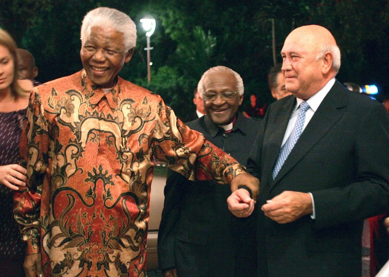 FILE - In this Friday, March 17 file photo former South African presidents Nelson Mandela, left, and FW de Klerk, right, with Anglican Archbishop Desmond Tutu, center, at de Klerk's 70th birthday party in Cape Town, South Africa. A new documentary film to be released, focuses on de Klerk who was the country's last white president and who, together with Mandela, plotted the historic transition to a multi-racial democracy, for which they were jointly awarded the Nobel Peace Prize in 1993  (AP Photo/Obed Zilwa-File)