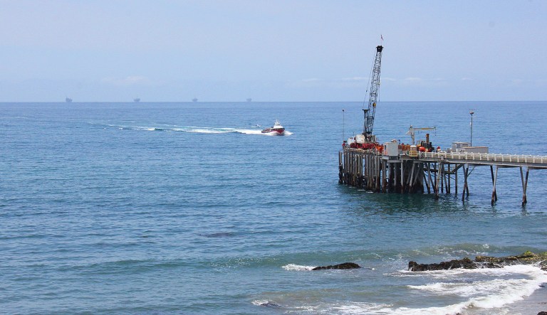 This 2015 photo shows oil drillings offshore of a service pier in the Santa Barbara Channel off the coast of Southern California near Carpinteria. (AP Photo/John Antczak)