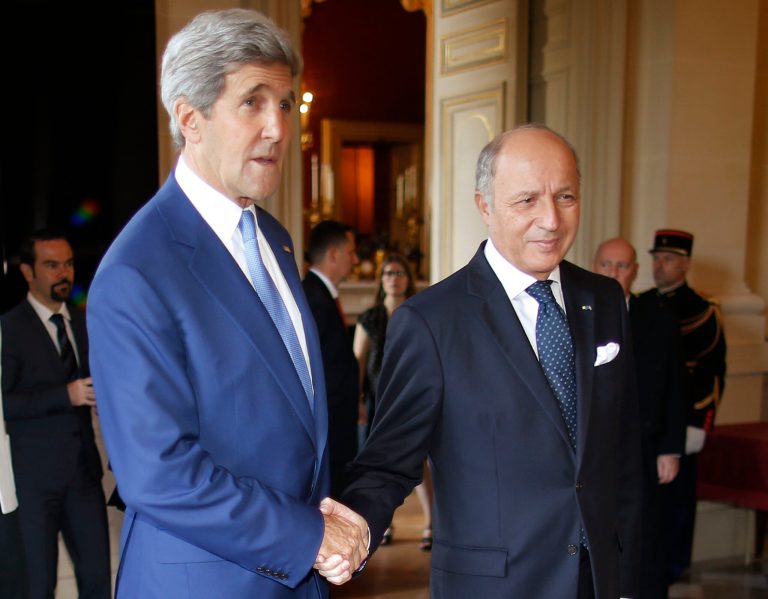 U.S. Secretary of State John Kerry, left, is greeted by France's Foreign Minister, Laurent Fabius, in Paris, France, Saturday, July 26, 2014. With a 12-hour humanitarian cease-fire in Gaza Saturday, Kerry is continuing his efforts to reach a longer truce between Israel and Hamas. (AP Photo/Charles Dharapak, Pool)