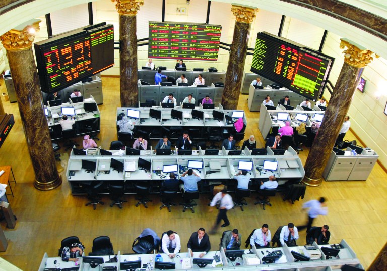 FILE - In this Wednesday, Oct. 29, 2008 file photo, Egyptian brokers work during a session at the Egyptian stock market in Cairo, Egypt. Egypt's benchmark stock index on Sunday plunged by more than 9.5 percent in the first trading session since the country's Islamist president issued decrees to assume sweeping new powers, while police in central Cairo fired tear gas at protesters who accuse the Egyptian leader of a blatant power grab. (AP Photo/Amr Nabil, File)
