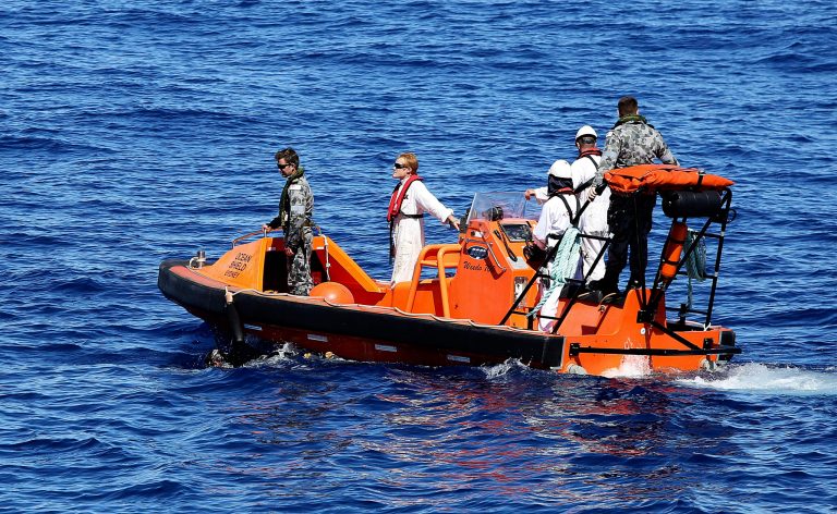 A fast response craft manned by members from the Australian Defense's ship Ocean Shield tows Able Seaman Clearance Diver Michael Arnold as they scan the water for debris of the missing Malaysia Airlines Flight 370 in the southern Indian Ocean.