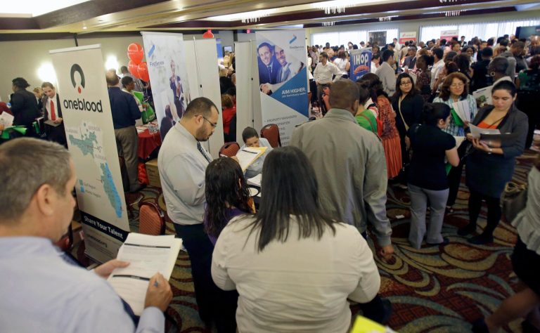   In this Wednesday, Aug. 14, 2013 photo, job seekers check out companies at a job fair in Miami Lakes, Fla. The Labor Department reports the number of Americans who applied for unemployment benefits for the first week of September on Thursday, Sept. 5, 2013. (AP Photo/Alan Diaz)  