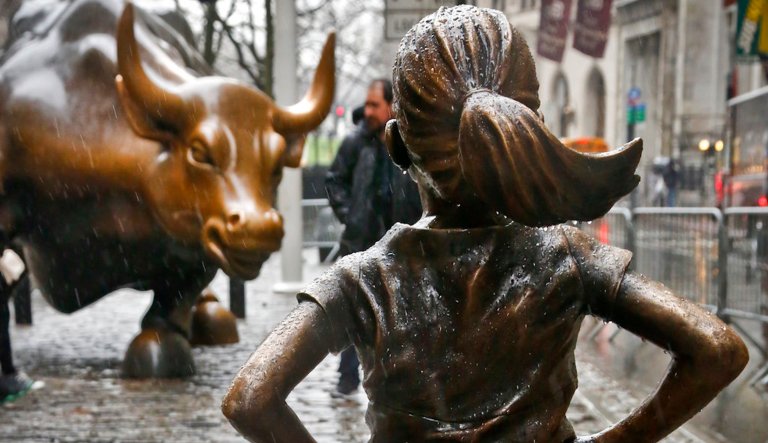 The "Fearless Girl" statue, created by Kristen Visbal, is shown during a drizzle, Monday March 27, 2017, in New York.  Mayor Bill de Blasio says the popular statue of a young girl staring down Wall Street's famous "Charging Bull" will be allowed to remain through February 2018.
