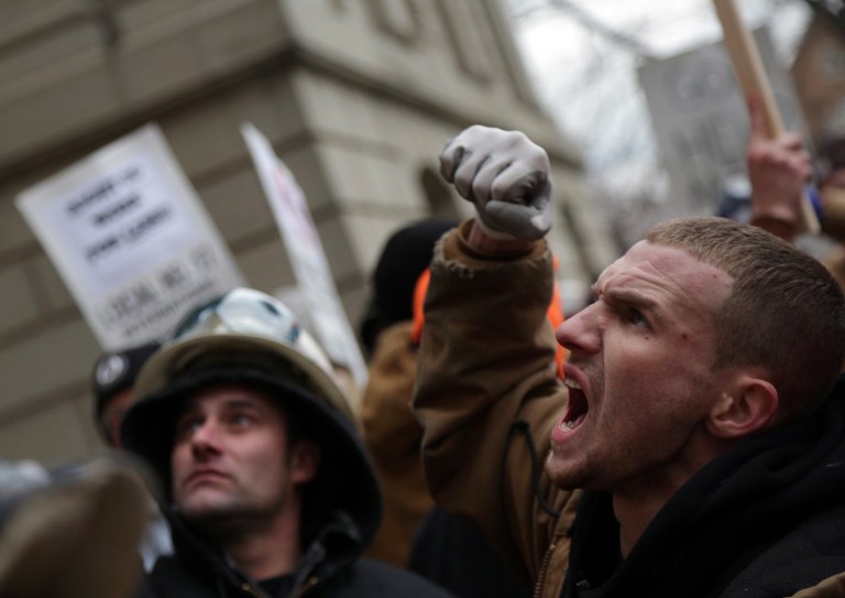   A crowd protests outside the state Capitol against two controversial right-to-work bills that the Michigan House of Representatives passed in Lansing, Mich. on Tuesday Dec. 11, 2012. As chants of angry protesters filled the Capitol, Michigan lawmakers gave final approval Tuesday to right-to-work legislation, dealing a devastating and once-unthinkable defeat to organized labor in a state that has been a bastion of the movement for generations. (AP Photo/Detroit Free Press, Romain Blanquart) DETROIT NEWS OUT; NO SALES  