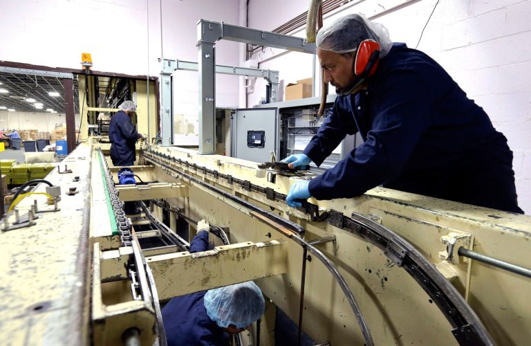 FILE - In this Wednesday, Oct. 16, 2013,  file photo, technicians repair machinery at Madelaine Chocolates factory in the Queens borough of New York.  The Federal Reserve reports on output from U.S. factories, mines and utilities in November on Monday, Dec. 16, 2013. (AP Photo/Frank Franklin II)