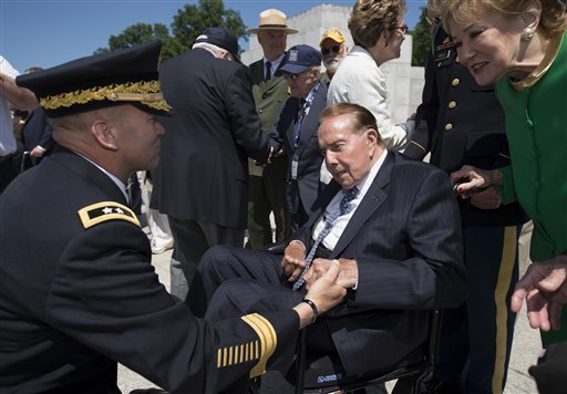 WWII veteran and former Senate Majority Leader Bob Dole is greeted by Major Gen. Jeffrey Buchanan after taking part in a wreath laying ceremony at a 10th anniversary ceremony for the WWII Memorial in Washington on May 24. (AP Photo/Molly Riley)