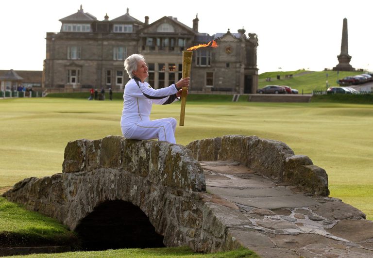   CAPTION CORRECTION, CORRECTS SOURCE OF PHOTO AND ADDS RESTRICTIONS - Louise Martin holds the Olympic Flame on the Swilken Bridge on the 18th fairway on the Old Course at St. Andrews on Day 26 of the London Torch Olympic Relay 2012, in St. Andrews, Scotland, Wednesday, June 13, 2012. (AP Photo/PA, Andrew Milligan) UNITED KINGDOM OUT, NO SALES, NO ARCHIVE  