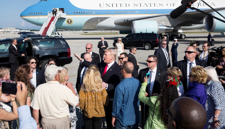 President Trump greets people on the tarmac as he arrives on Air Force One at Palm Beach International Airport, in West Palm Beach, Fla. (AP Photo/Carolyn Kaster)