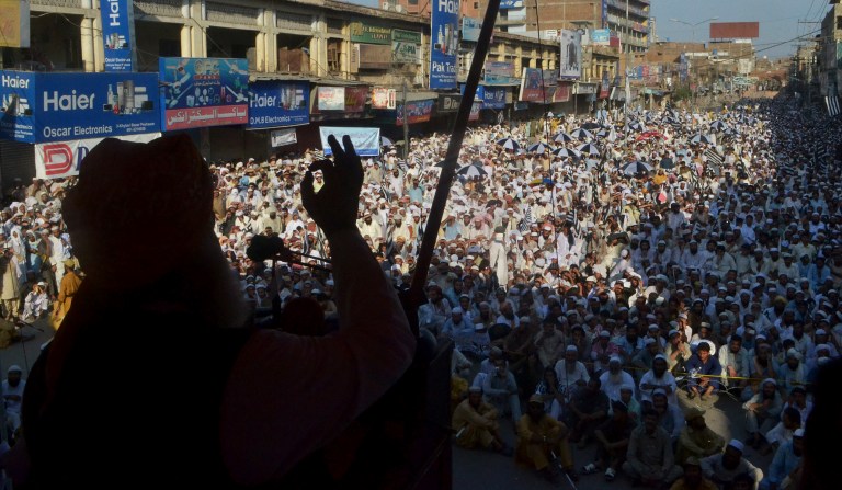 Fazal-ur-Rehman, chief of Pakistan Ulema-e-Islam speaks during a rally to support Prime Minister Nawaz Sharif in Peshawar, Pakistan, Sunday, Aug. 31, 2014. Thousands of anti-government protesters, in the meantime, tried to raid the official residence of Sharif, sparking clashes with police that killed a few people and wounded hundreds amid cries for the premier to step down, officials said Sunday. (AP Photo/Mohammad Sajjad)