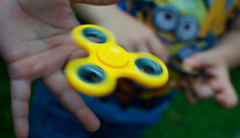 A boy plays with a fidget spinner in Moscow, Russia, on Wednesday, July 19, 2017. Russian authorities are investigating fidget spinners after state television reported that opposition activists are using them to attract supporters.
