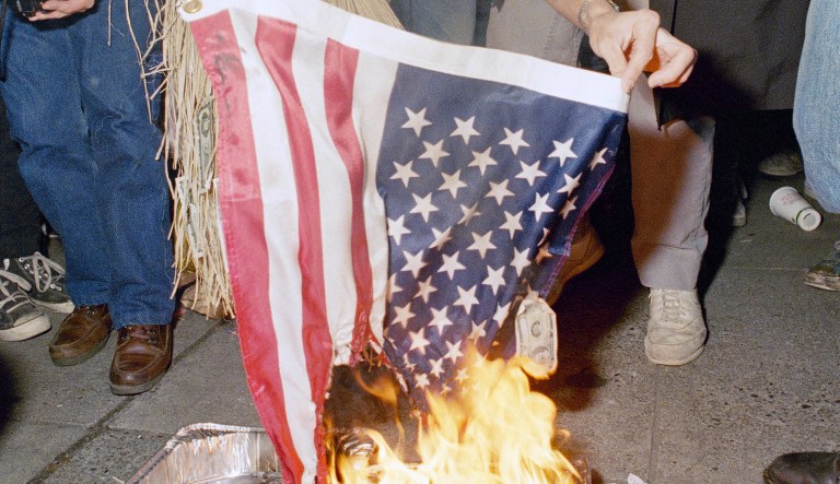 A Seattle resident, who refused to identify himself, burns an American flag in Seattle Saturday morning, Oct. 28, 1989 a few moments after a federal anti-flag burning law went into effect.