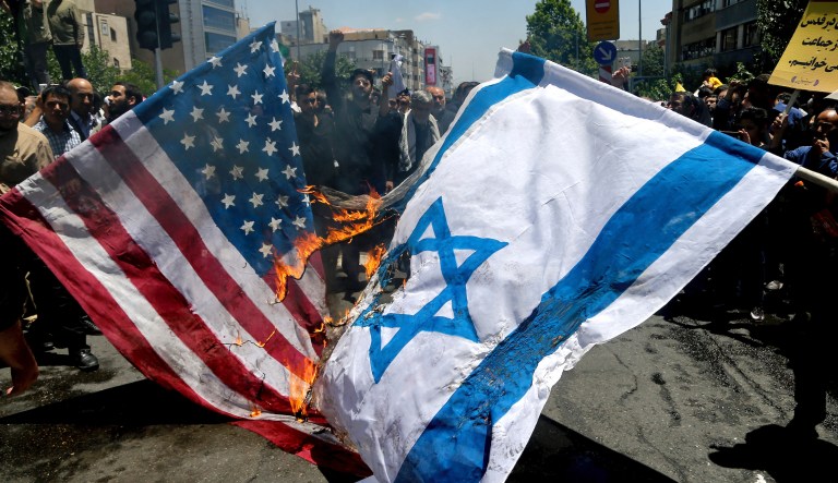 Iranian protesters burn Israeli and U.S. flags in their annual anti-Israeli Al-Quds, Jerusalem, Day rally in Tehran, Iran, Friday, June 8, 2018. Iranians attended the rallies across the country to condemn Israeli occupation of Palestinian territories.