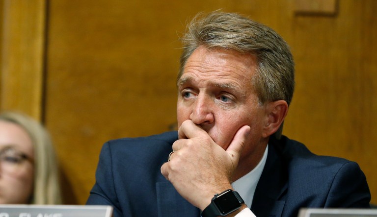 Sen. Jeff Flake, R-Ariz., listens as Christine Blasey Ford testifies before the Senate Judiciary Committee hearing, Thursday, Sept. 27, 2018 on Capitol Hill in Washington. 