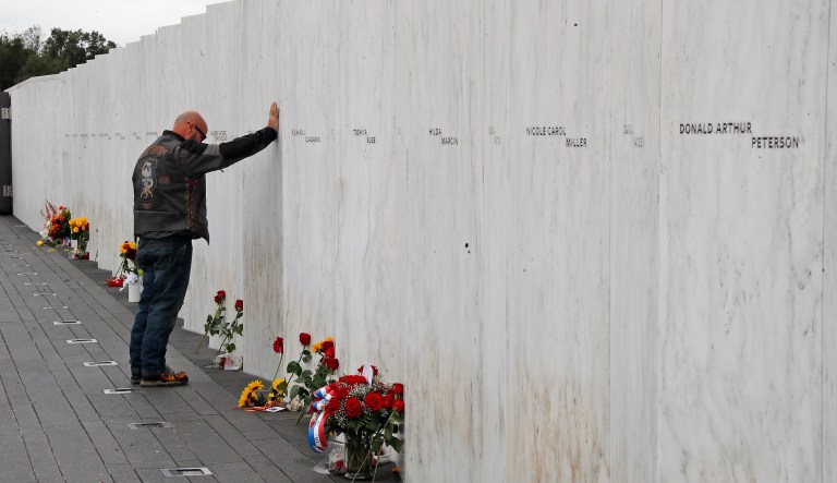A visitor to the Flight 93 National Memorial in Shanksville, Pa. pays his respects at the Wall of Names after a Service of Remembrance Tuesday, Sept. 11, 2018, as the nation marks the 17th anniversary of the Sept. 11, 2001 attacks. The Wall of Names honor the 40 people killed in the crash of Flight 93. 